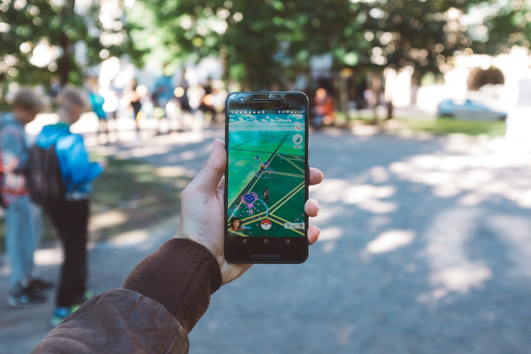 services-03 person-playing-pokemon-go-during-daytime-am1io6kusfm